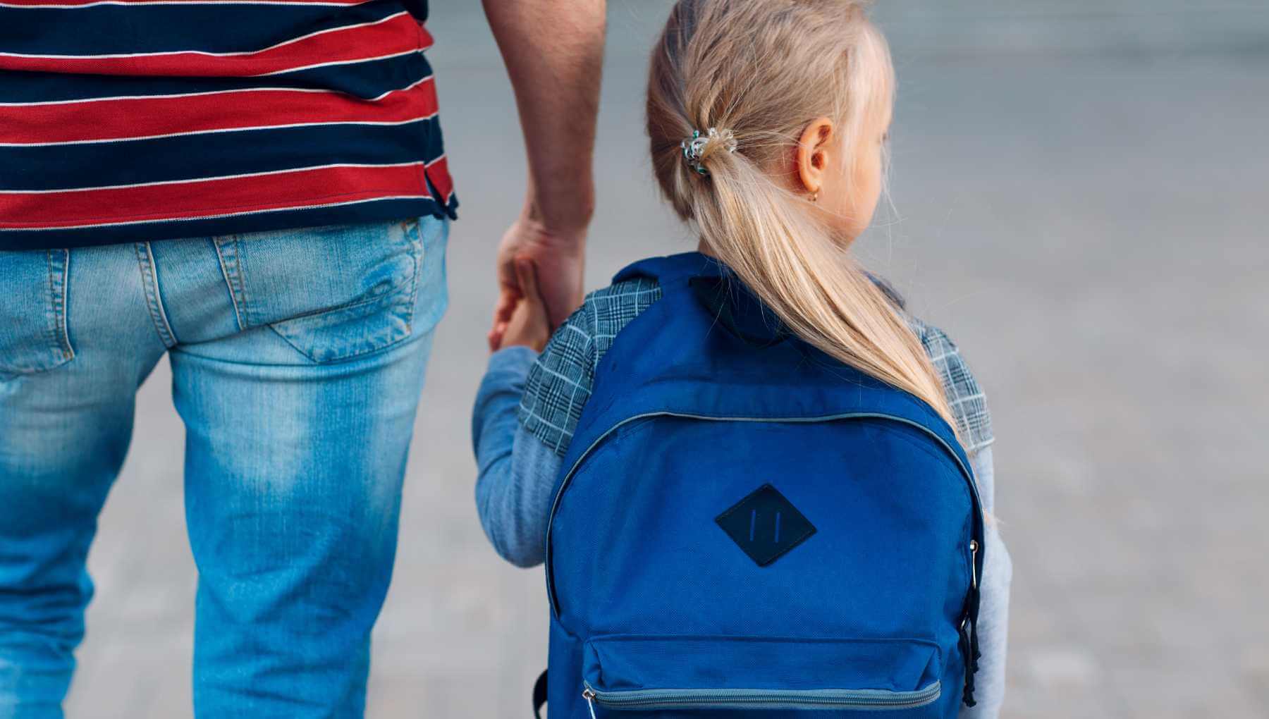 Child showing signs of sepanx while clinging to parent